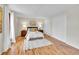 Inviting bedroom with hardwood floors, two closets, and a large window at 3766 E Easter S Cir, Centennial, CO 80122