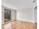 Bright bedroom with hardwood floors and a window showing trees outside at 3766 E Easter S Cir, Centennial, CO 80122