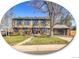 Charming two-story home with red brick accents, a large tree, and a glass garage door at 3766 E Easter S Cir, Centennial, CO 80122
