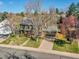 Charming two-story home with a brick chimney, mature trees, and a well-manicured lawn at 3766 E Easter S Cir, Centennial, CO 80122