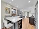 Bright kitchen featuring a large island with seating and modern countertops at 3766 E Easter S Cir, Centennial, CO 80122