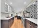 Well-lit kitchen boasts stainless steel appliances, stylish backsplash, and hardwood floors at 3766 E Easter S Cir, Centennial, CO 80122