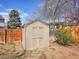 A sturdy wooden storage shed in the backyard, offering ample space for tools and garden equipment at 3766 E Easter S Cir, Centennial, CO 80122