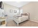 Cozy bedroom with natural light, soft colors, and comfortable bed with throw blanket at 17890 Calendula Dr, Parker, CO 80134