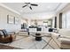 Spacious living room open to the kitchen, and a large sectional sofa at 17890 Calendula Dr, Parker, CO 80134