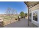 Spacious back deck features stone columns, iron railing, and golf course view at 21231 E Saddle Rock Ln, Aurora, CO 80016