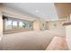 A finished basement featuring lots of windows and neutral colored carpet at 21231 E Saddle Rock Ln, Aurora, CO 80016
