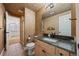 Bathroom featuring granite countertops, decorative walls, and tiled flooring at 21231 E Saddle Rock Ln, Aurora, CO 80016