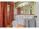 Bathroom features a pedestal sink, red patterned curtains, and vintage accents at 21231 E Saddle Rock Ln, Aurora, CO 80016