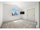 Bright bedroom with a large window and closet, complemented by neutral colors and plush carpeting at 21231 E Saddle Rock Ln, Aurora, CO 80016