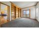 Bonus room featuring a wall of built-in shelves and sliding glass door to balcony at 21231 E Saddle Rock Ln, Aurora, CO 80016