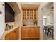 Butler pantry with natural wood cabinets and decorative archway detail at 21231 E Saddle Rock Ln, Aurora, CO 80016