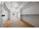 Spacious walk-in closet with ample shelving and storage, featuring hardwood floors and a large window at 21231 E Saddle Rock Ln, Aurora, CO 80016
