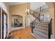 Grand two story foyer with staircase and arched doorways at 21231 E Saddle Rock Ln, Aurora, CO 80016