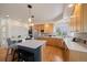 Bright kitchen featuring stainless steel appliances, wood cabinets, large island, and cozy breakfast bar seating at 21231 E Saddle Rock Ln, Aurora, CO 80016