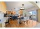 Spacious kitchen with wood cabinets, stainless steel appliances, island with seating and access to an outdoor deck at 21231 E Saddle Rock Ln, Aurora, CO 80016