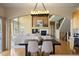Open concept living room with modern fireplace, dining area, and staircase at 21231 E Saddle Rock Ln, Aurora, CO 80016