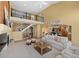 Spacious living area with open layout, showcasing high ceilings, staircase and seamless flow to the kitchen at 21231 E Saddle Rock Ln, Aurora, CO 80016