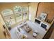 Bright living room with vaulted ceilings, large windows offering serene landscape views, and a cozy fireplace feature at 21231 E Saddle Rock Ln, Aurora, CO 80016