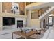 Living area with a fireplace, staircase, and open layout, showcasing a blend of comfort and architectural style at 21231 E Saddle Rock Ln, Aurora, CO 80016