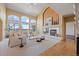 Bright living room with vaulted ceilings, large windows offering views, and a cozy fireplace for a relaxing atmosphere at 21231 E Saddle Rock Ln, Aurora, CO 80016