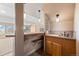 Basement wet bar area featuring a tile counter, sink, and cabinetry, perfect for entertaining guests at 21231 E Saddle Rock Ln, Aurora, CO 80016