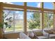 Large windows in the living room showcase lush green views of the surrounding landscape and golf course beyond at 21231 E Saddle Rock Ln, Aurora, CO 80016
