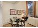 Cozy dining area with a glass table set and natural light from the large windows at 2378 Hearth Dr # 6, Evergreen, CO 80439