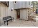 Charming entryway with a wooden front door, a bench, and fresh landscaping at 2378 Hearth Dr # 6, Evergreen, CO 80439