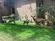 Charming front yard with lush green grass, deer, and a two-story building in the background at 2378 Hearth Dr # 6, Evergreen, CO 80439