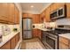 Modern kitchen with stainless steel appliances, light wood cabinets, and granite counters at 2378 Hearth Dr # 6, Evergreen, CO 80439
