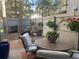 Inviting patio with an outdoor dining set and hanging flower baskets, creating a charming outdoor space at 2378 Hearth Dr # 6, Evergreen, CO 80439