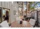 Cozy outdoor patio with string lights, dining set, and tranquil surroundings, perfect for relaxing and entertaining at 2378 Hearth Dr # 6, Evergreen, CO 80439