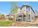 Relaxing backyard oasis features a spiral staircase and a covered patio with a hot tub at 9371 Desert Willow Trl, Highlands Ranch, CO 80129
