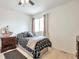 Cozy bedroom with modern decor and a patterned bedspread at 9371 Desert Willow Trl, Highlands Ranch, CO 80129