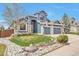 Charming two-story home featuring a well-maintained lawn, rock garden and a two-car garage at 9371 Desert Willow Trl, Highlands Ranch, CO 80129