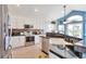 Modern kitchen with white cabinets, granite countertops, and stainless steel appliances at 9371 Desert Willow Trl, Highlands Ranch, CO 80129