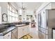 Open-concept kitchen showcasing modern appliances and bright living space beyond at 9371 Desert Willow Trl, Highlands Ranch, CO 80129