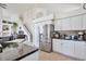 Modern kitchen with stainless steel appliances, black countertops, and white cabinets, adjacent to staircase at 9371 Desert Willow Trl, Highlands Ranch, CO 80129