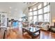 Spacious open-concept living room with hardwood floors, ample natural light and modern kitchen at 9371 Desert Willow Trl, Highlands Ranch, CO 80129