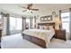 Spacious main bedroom with large bed, bay window, and neutral tones, creating a serene atmosphere at 9371 Desert Willow Trl, Highlands Ranch, CO 80129