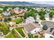 Beautiful aerial view of the home with its large yard, landscaping, and mountain views at 9620 Mallard Pond Way, Littleton, CO 80125