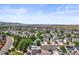 Aerial view of a sprawling neighborhood, showcasing rooftops, roads and beautiful landscape at 9620 Mallard Pond Way, Littleton, CO 80125