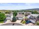 Suburban homes and street view surrounded by fields and mountains in an aerial view at 9620 Mallard Pond Way, Littleton, CO 80125