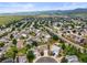 Wide aerial shot of a neighborhood, a pond, mountain views, and surrounding homes at 9620 Mallard Pond Way, Littleton, CO 80125