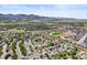 A panoramic view showing neighborhoods with mountain views, a large field, and a small lake at 9620 Mallard Pond Way, Littleton, CO 80125