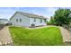 Well-maintained backyard features a large, green lawn and a charming wooden fence at 9620 Mallard Pond Way, Littleton, CO 80125