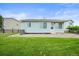 Well-maintained backyard with green grass, wood fence, and rock landscaping at 9620 Mallard Pond Way, Littleton, CO 80125