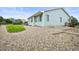 Landscaped backyard features green grass, gravel ground cover, and a wooden fence at 9620 Mallard Pond Way, Littleton, CO 80125