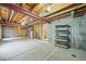 Unfinished basement with exposed wood ceiling, concrete floor, and storage space at 9620 Mallard Pond Way, Littleton, CO 80125